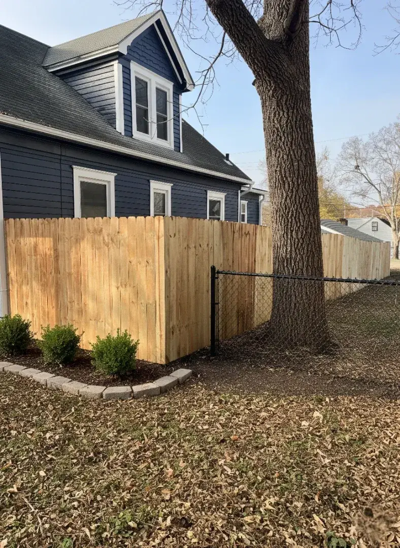 Wood fence with custom gate installed by Kingdom Builders