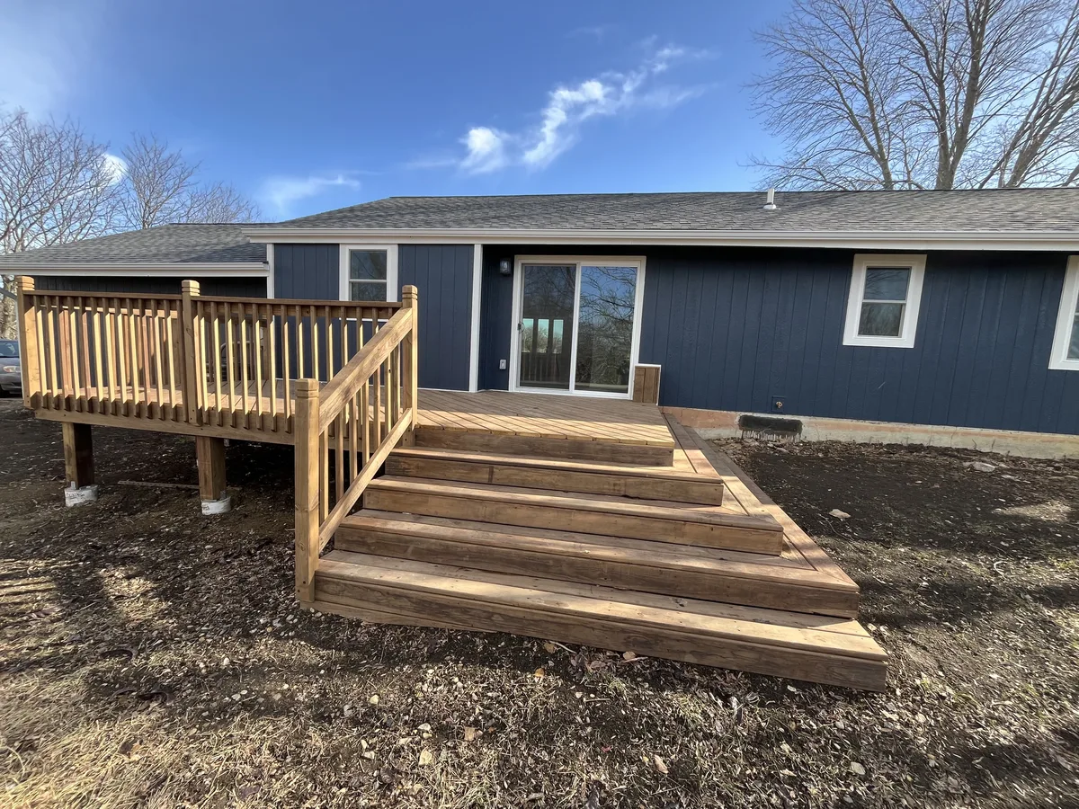 Completed deck project with railing by Kingdom Builders