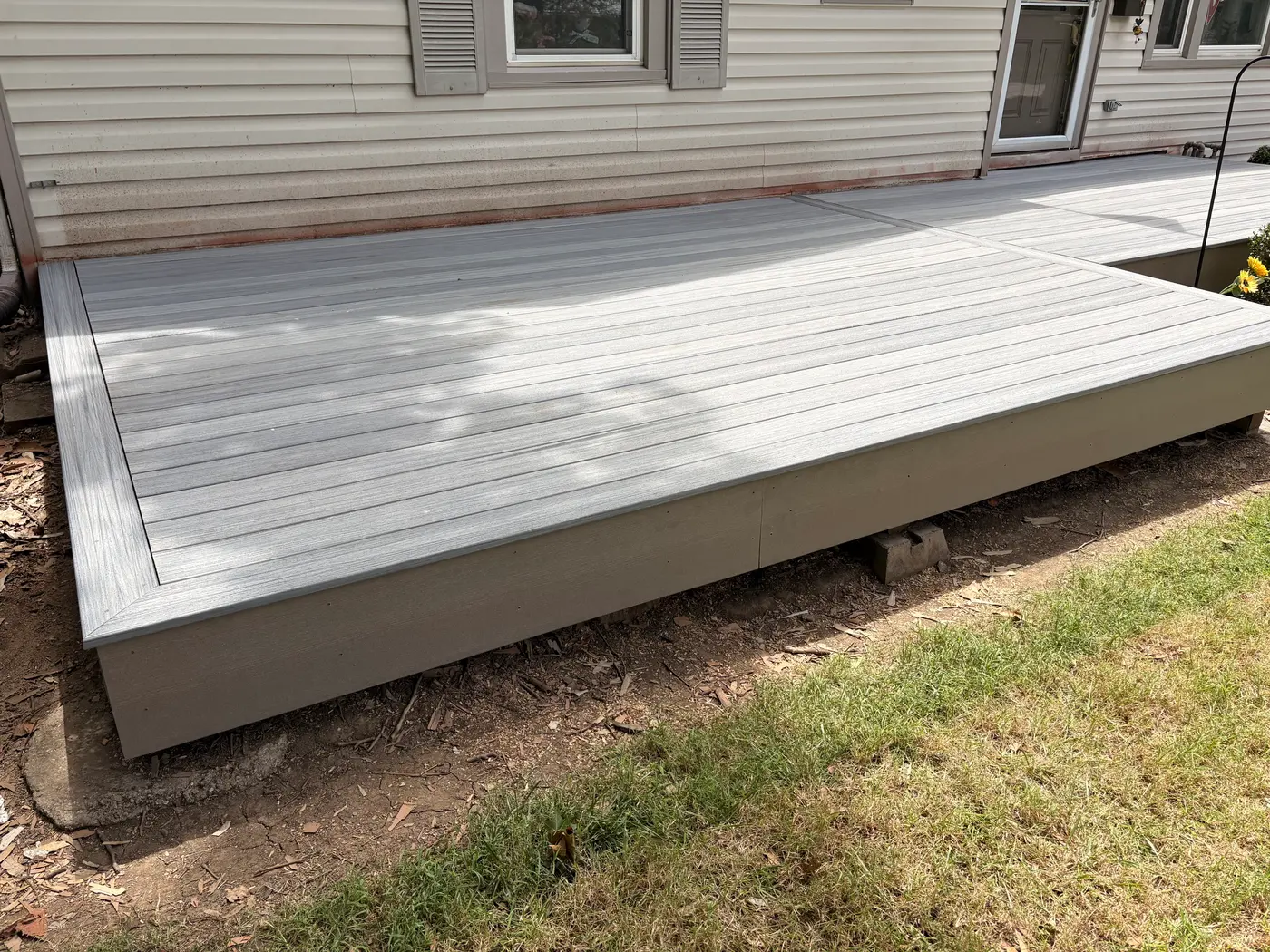 Grey composite deck surface and fascia board in a Topeka, KS backyard