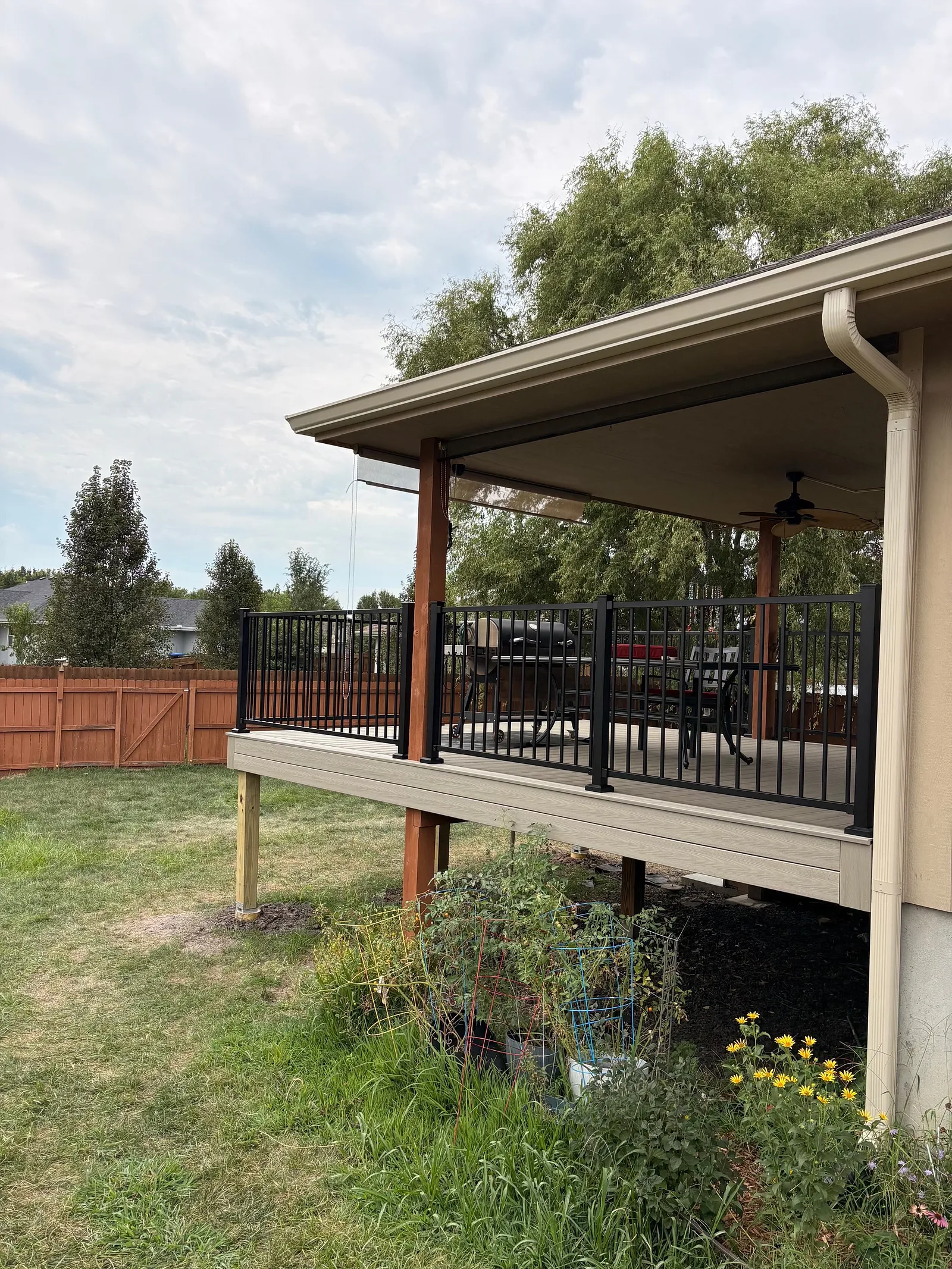 Deck posts and rail Elevated deck posts on concrete footings with black metal railing in a Topeka, KS backyard