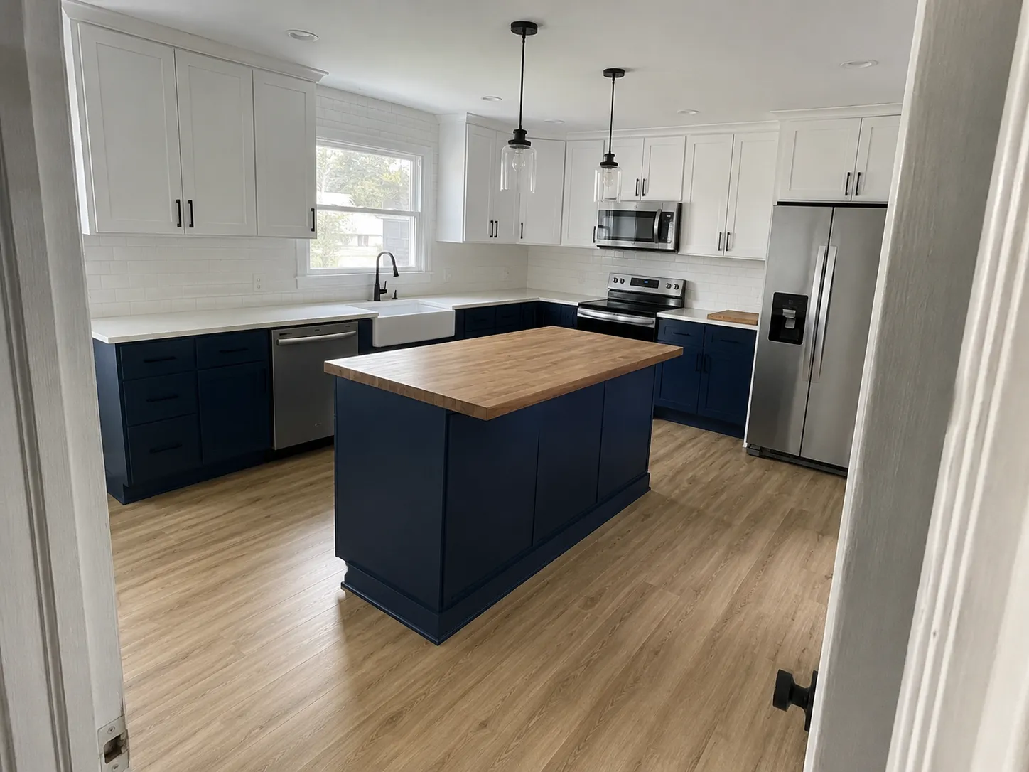 Two-tone kitchen remodel, Topeka KS Kitchen remodel in Topeka, KS with navy and white shaker cabinets and a butcher block island