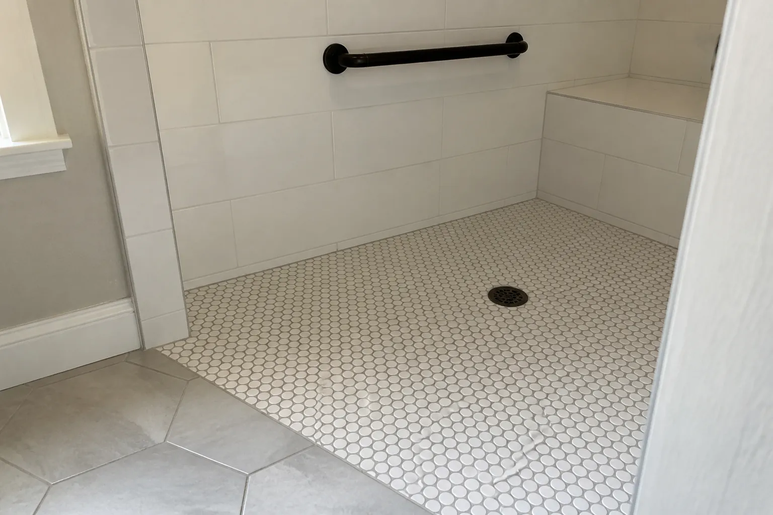 Tiled shower pan detail Mosaic tile shower pan and drain detail, typical of a tiled bathroom remodel in Topeka, KS
